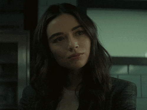 a close up of a woman 's face with a serious look on her face .