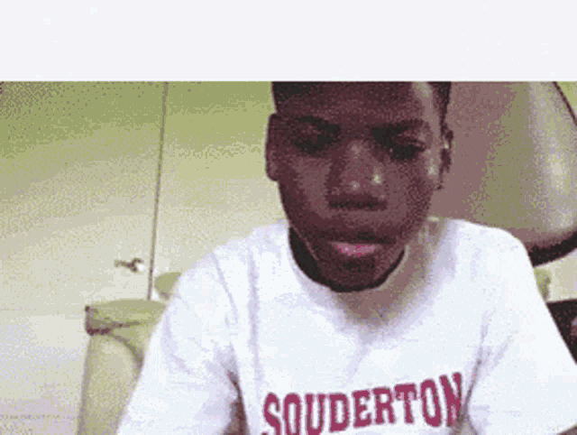 a young man wearing a souderton t-shirt