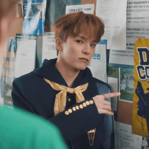 a young man pointing at a sign that says " getting a permission "