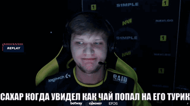a man wearing headphones and a paid shirt