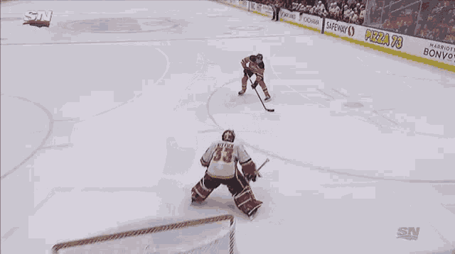 a hockey game is being played in a stadium with tim hortons on the sidelines