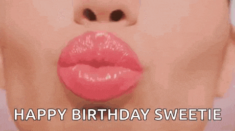 a close up of a woman 's lips with the words `` happy birthday sweetie '' written below it .