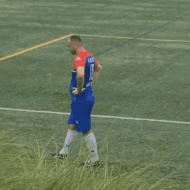 a soccer player wearing a blue and red jersey with the letter a on the shorts