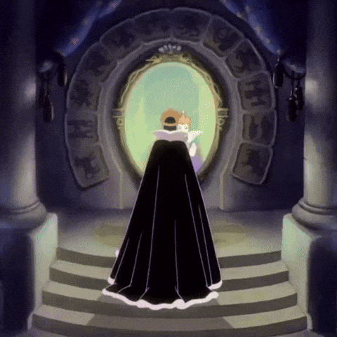 a woman in a black cape stands in front of a mirror with a crown on her head