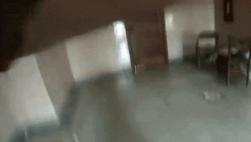 a blurry picture of a room with a clock on the wall .