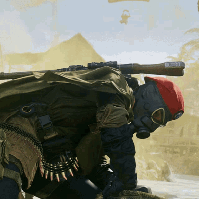 a man wearing a gas mask and a red beret holds a gun