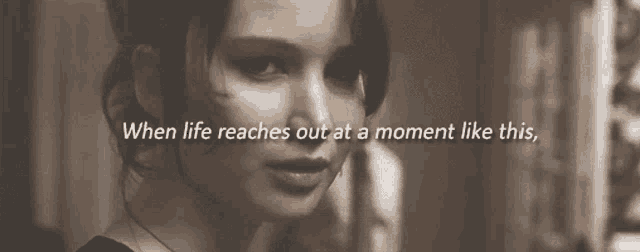 a black and white photo of a woman with the words " when life reaches out at a moment like this " below her