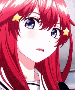 a close up of a girl with red hair and blue eyes with a star in her hair .