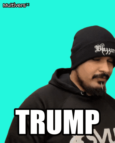 a man wearing a beanie and a black hoodie with the word trump on it