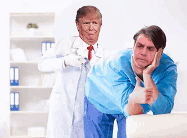 a man in a blue shirt is giving a thumbs up while a doctor in a white coat stands behind him