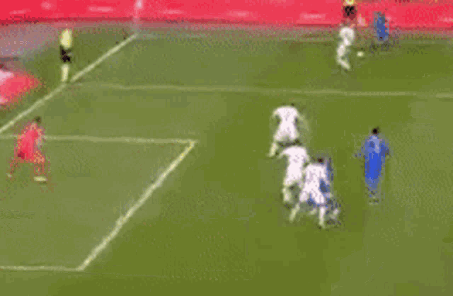 a soccer game is being played on a soccer field with a goalie .