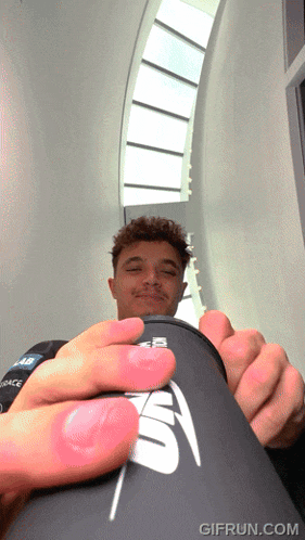 a man is holding a can that says ' gifrun.com ' on the bottom