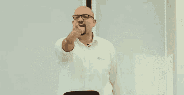 a bald man wearing glasses and a white shirt with a name tag that says ' allianz '