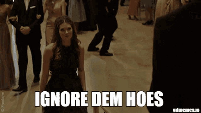 a woman in a purple dress is walking down a hallway with the words ignore dem hoes written below her