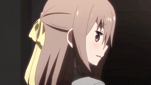 a girl with brown hair and a yellow bow on her head