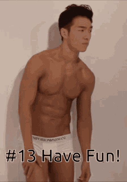 a shirtless man in white underwear is standing in front of a white wall with the caption # 13 have fun