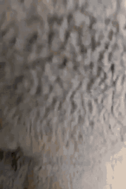 a close up of a gray surface with a texture