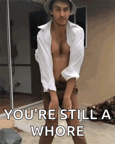 a shirtless man is standing in front of a sliding glass door with the words " you 're still a whore " below him