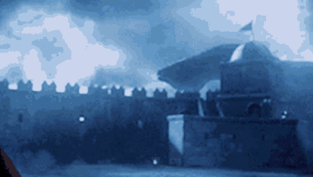 a castle with a flag on top of it in the middle of the night