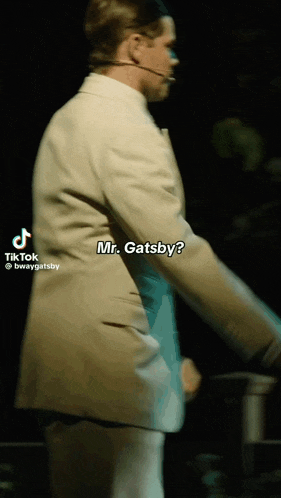 a tiktok video of a man in a tan suit dancing with the caption mr. gatsby