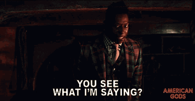 a poster for american gods shows a man in a plaid suit
