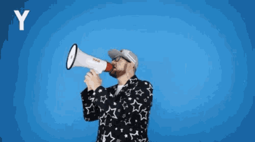 a man is holding a megaphone in front of a blue background and says ya