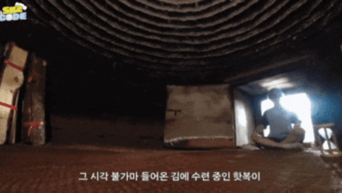 a man sits in a dark room with a sign that says sea code on the top