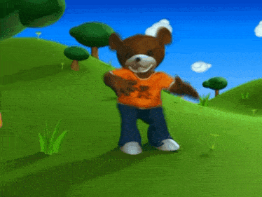 a teddy bear wearing an orange shirt with a bear on it is standing in a grassy field