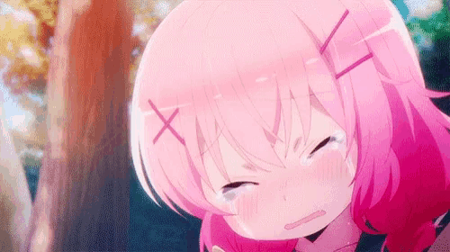 a girl with pink hair is crying with her eyes closed and a tree in the background .