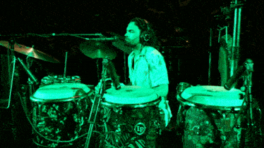a man playing drums with a lp logo