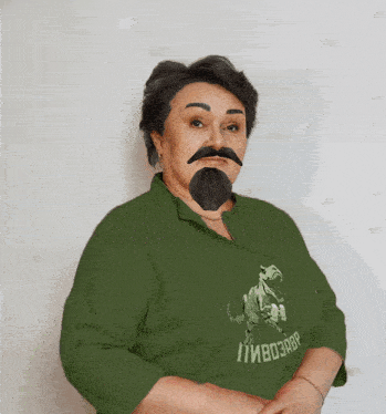 a woman with a fake beard and mustache is wearing a green shirt that says " пивозавр "