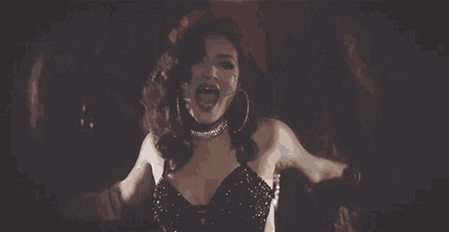 a woman in a black dress is screaming in front of the word jesusa