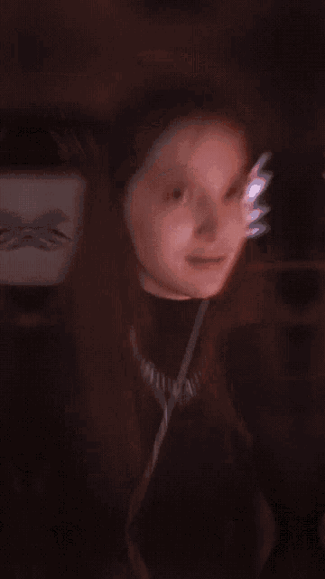 a woman is wearing headphones and smiling in front of a sign that says warp