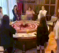 a group of people are gathered around a roulette wheel