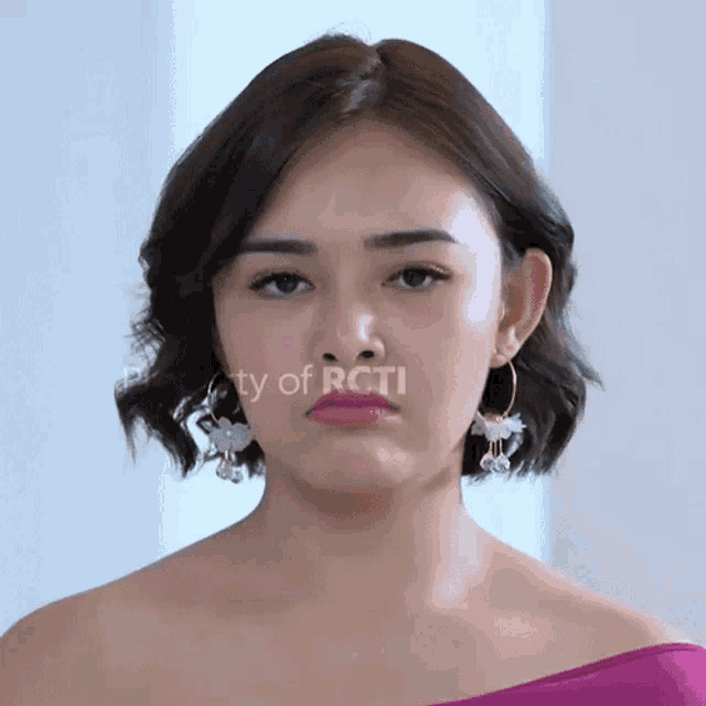 a close up of a woman 's face with the words property of rcti