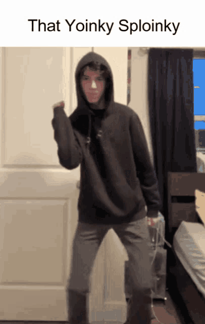 a person in a hoodie is standing in front of a door that says that yoinky sploinky on it