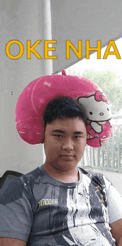 a man with a hello kitty pillow on his head is wearing a soccer jersey