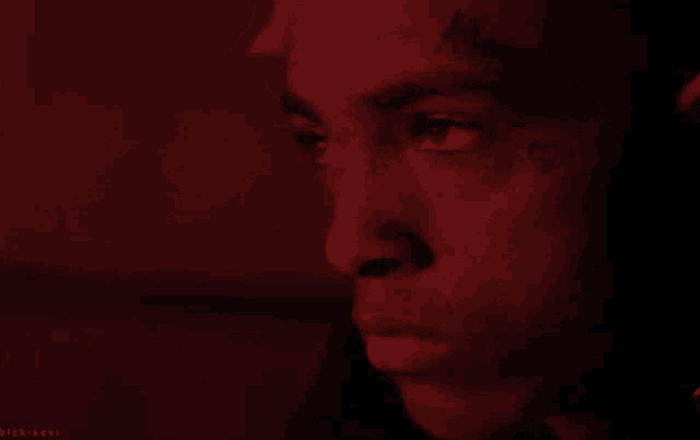 a close up of a person 's face with a red background