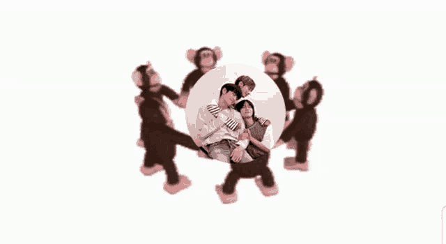 a group of stuffed monkeys are dancing around a picture of a man