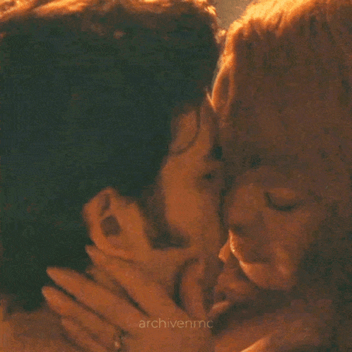 a close up of a man and woman kissing with the words archivenmc in the corner