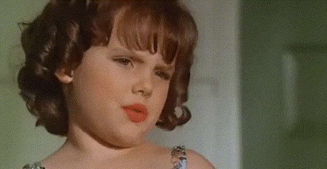a little girl with a necklace around her neck