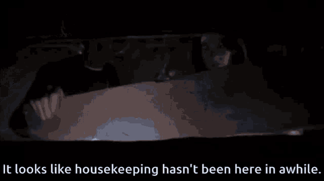 a person in a dark room with the words it looks like housekeeping hasn t been here in awhile