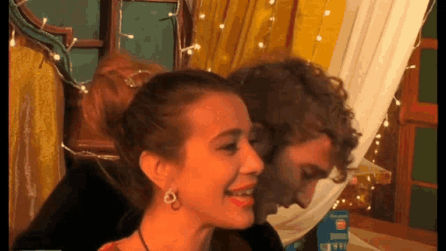 a man and a woman are looking at each other with a box in the background that says ' for good '