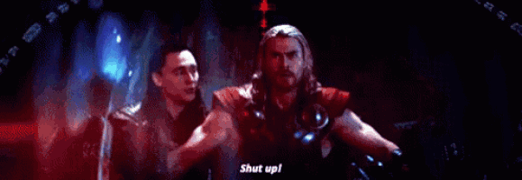 thor is standing in a dark room with a blue light coming out of his hands and says `` shut up ! ''