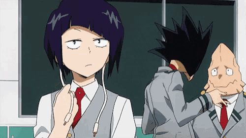 a group of anime characters are standing next to each other in front of a blackboard in a classroom .