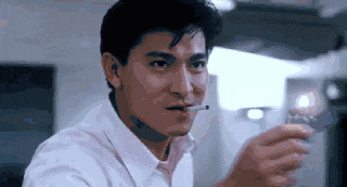 a man in a white shirt is smoking a cigarette and drinking a glass of water .