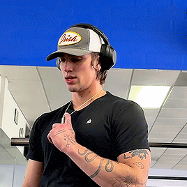 a man wearing headphones and a hat that says irish on it