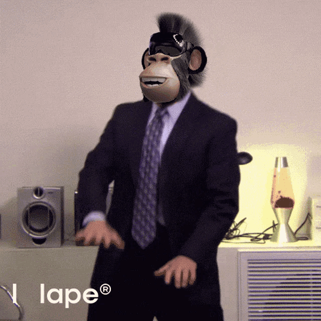 a man in a suit with a monkey mask on his head