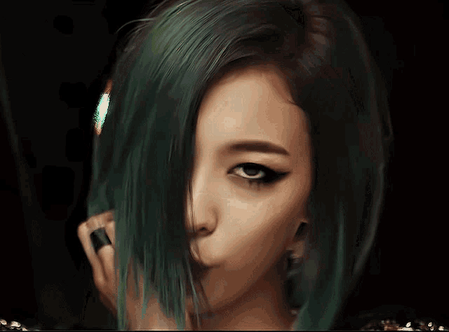a close up of a woman 's face with green hair and a black eye
