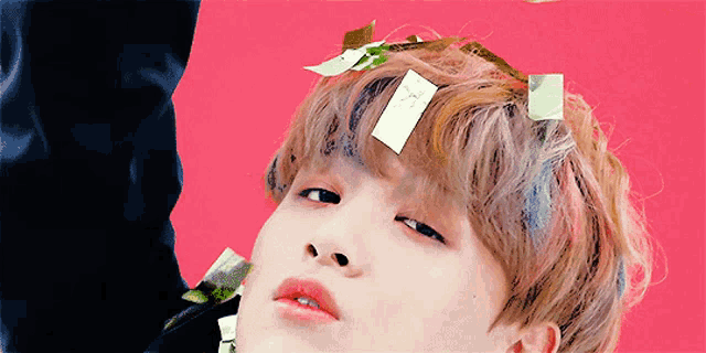 a close up of a person 's face with sticky notes on their hair